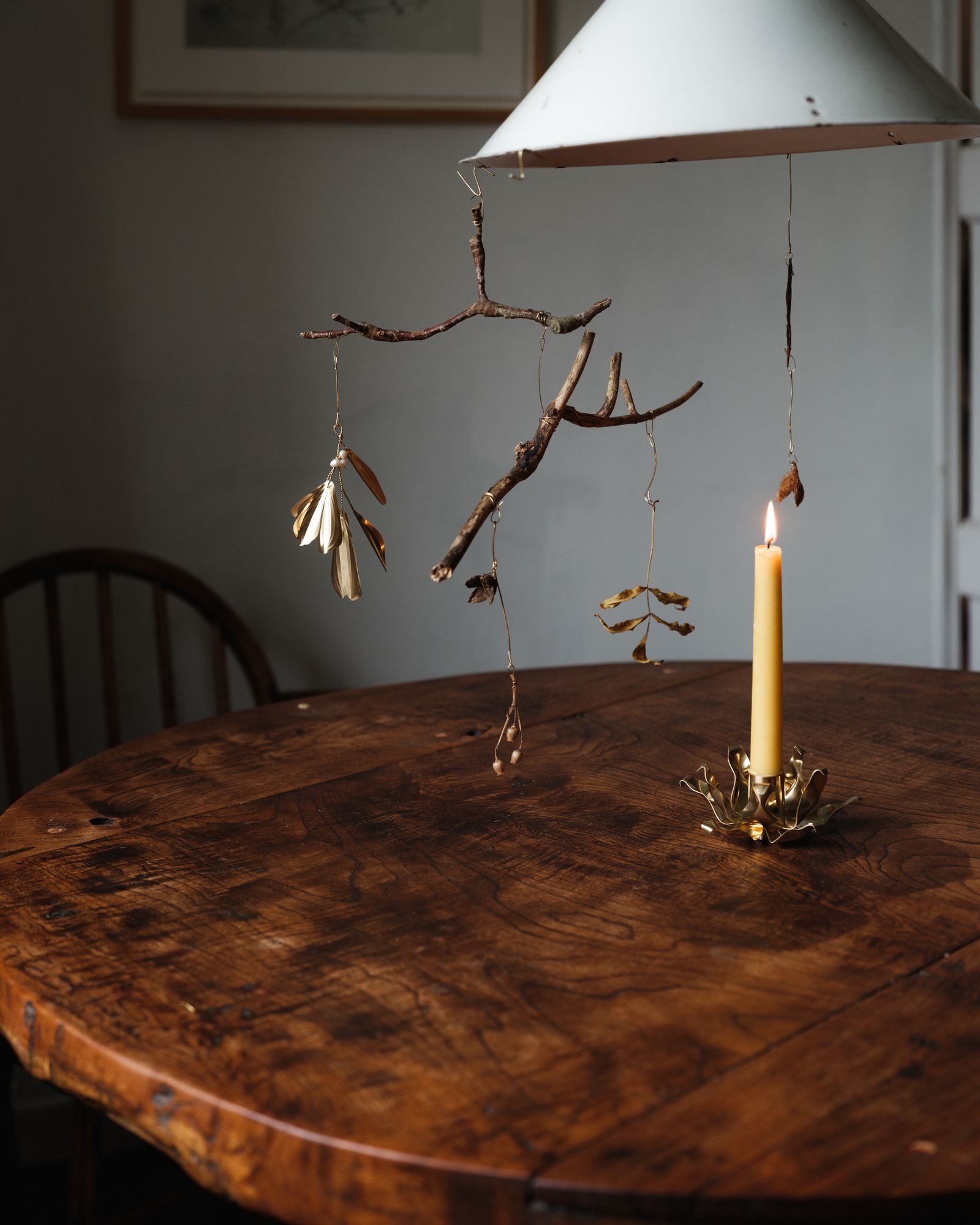 Image may contain Furniture Table Tabletop Wood Lamp Chair Hardwood Stained Wood Candle Art and Painting