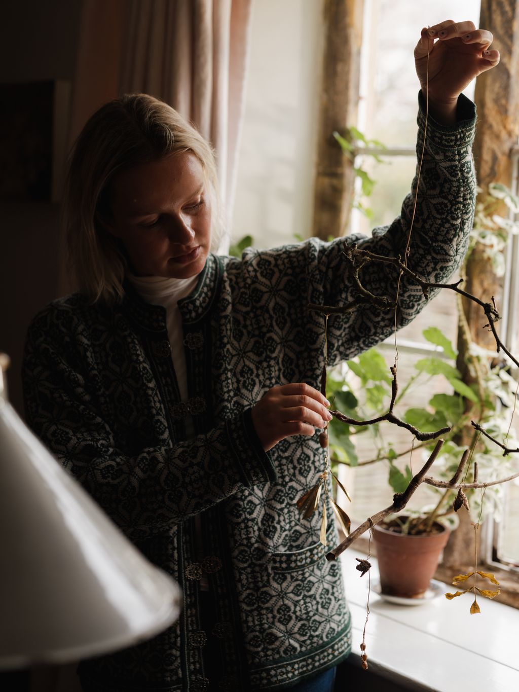 Image may contain Adult Person Clothing Knitwear Sweater Head Face and Lamp