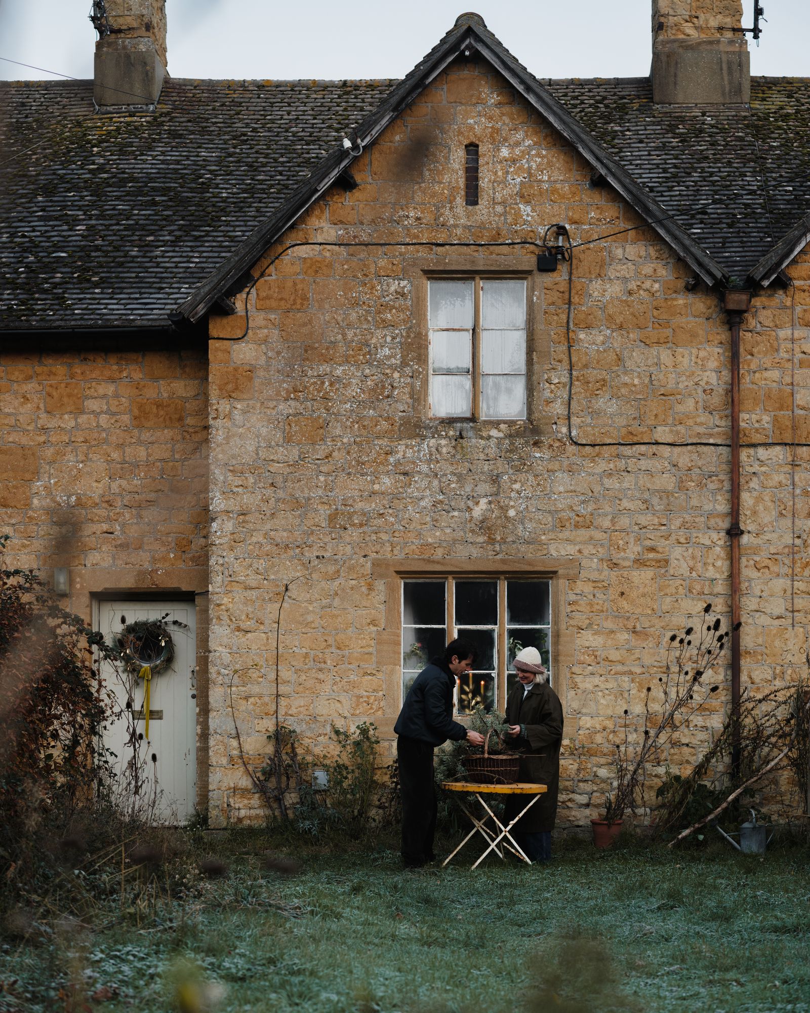 Image may contain Architecture Building Cottage House Housing Adult Person Outdoors Shelter and Nature