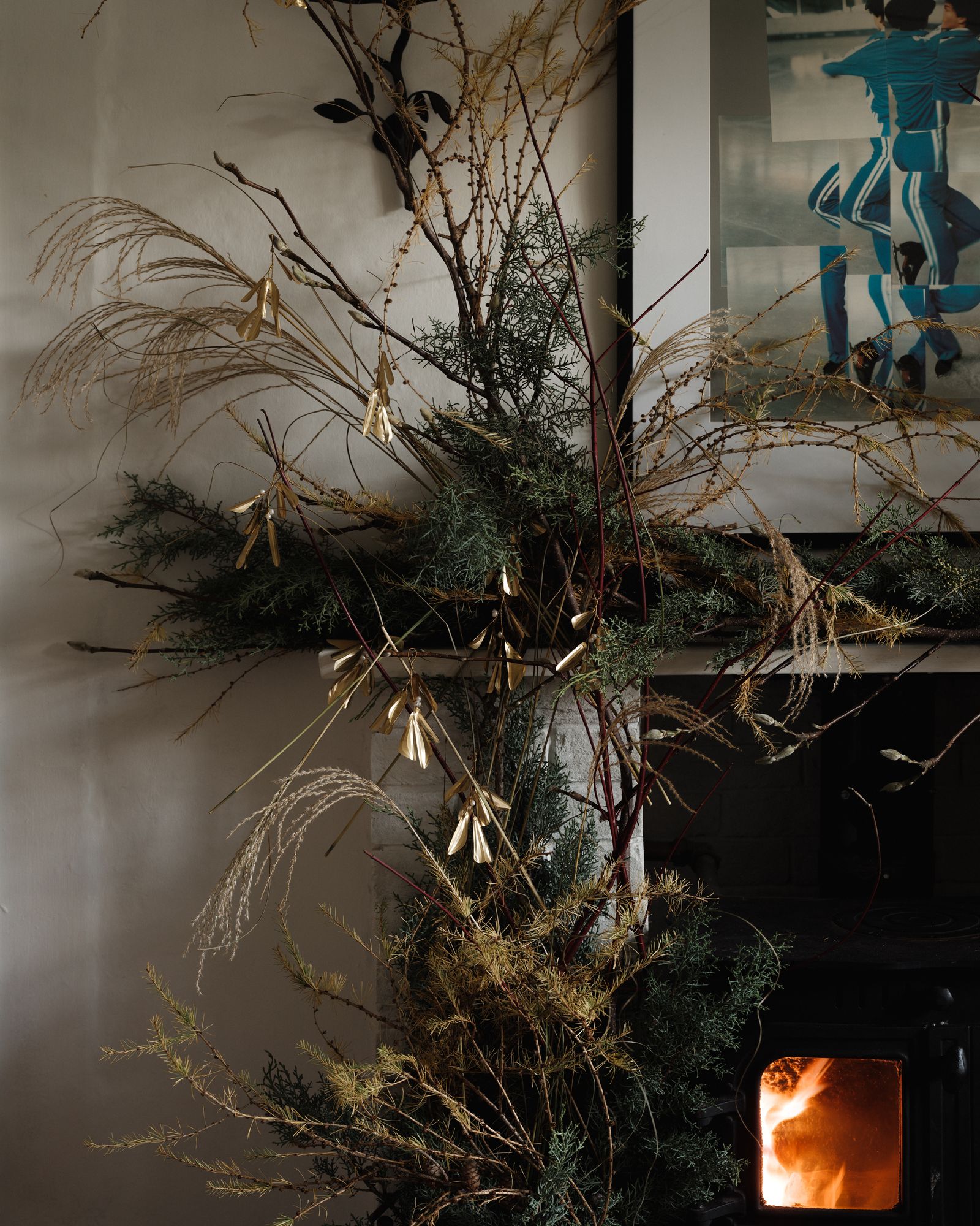 Image may contain Plant Tree Fireplace Indoors Christmas Christmas Decorations Festival Person and Christmas Tree