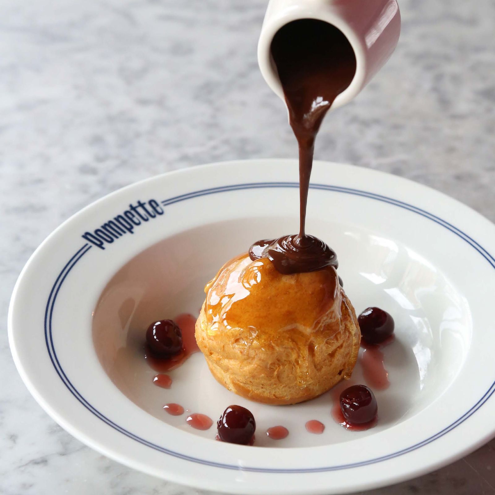 Kirsch choux bun, griottines cherries & warm chocolate sauce